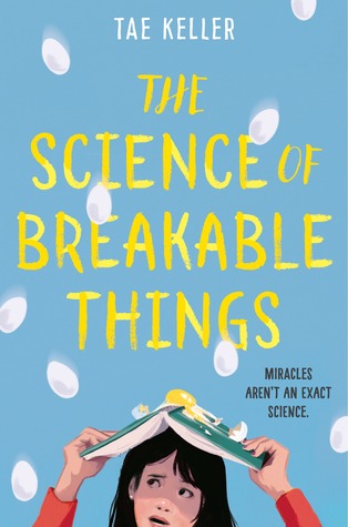 The front cover of The Science of Breakable Things features the protagonist holding a book over her head to shelter her from falling eggs.