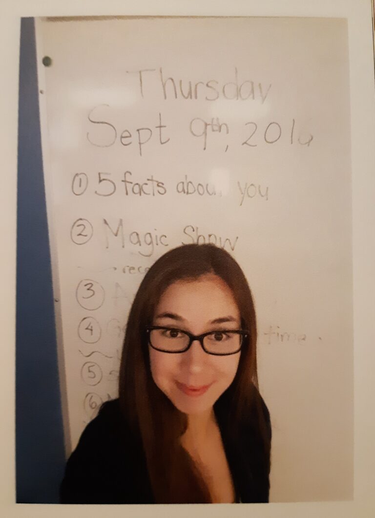 Larissa stands in front of a whiteboard dated "Thursday, September 9th, 2016". Underneath, it says, "5 Facts About You, Magic show..." the rest is cut off by her head.